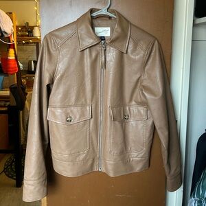 Faux leather zip up jacket with pockets.